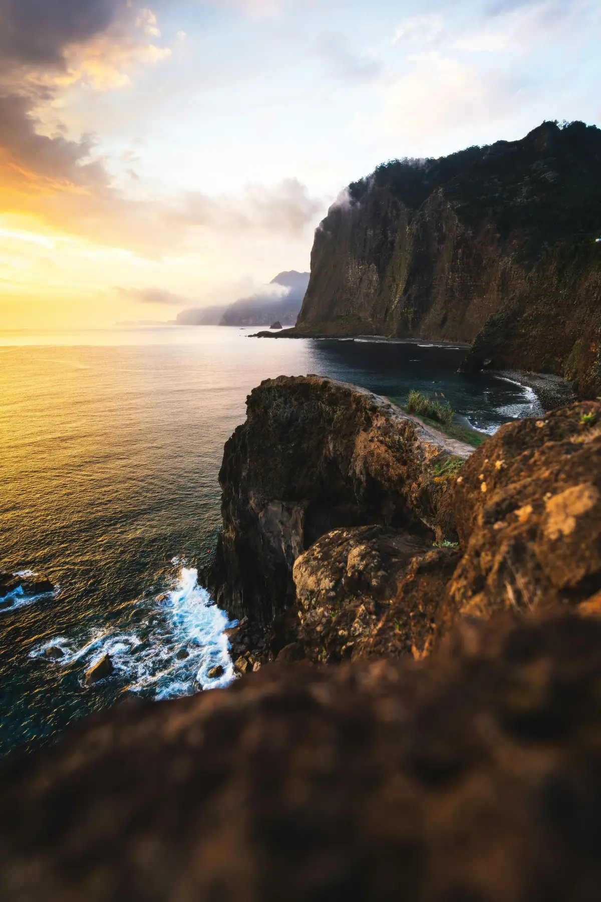 Dramatic coastal cliffside overlooking the ocean at sunset