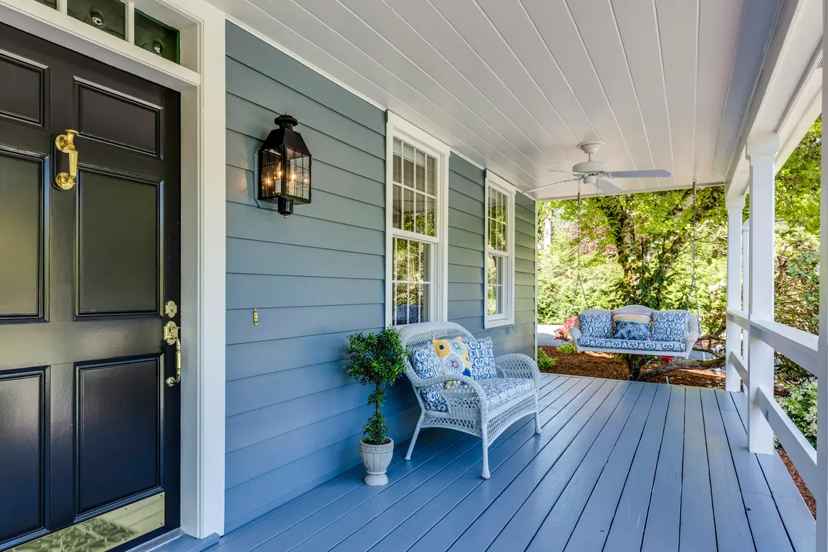 A porch with two chairs and a table, warm natural light