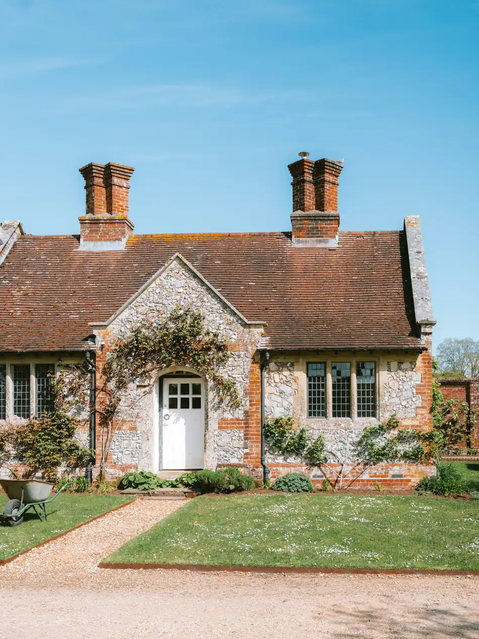 Charming stone cottage with a red tile roof in a countryside setting